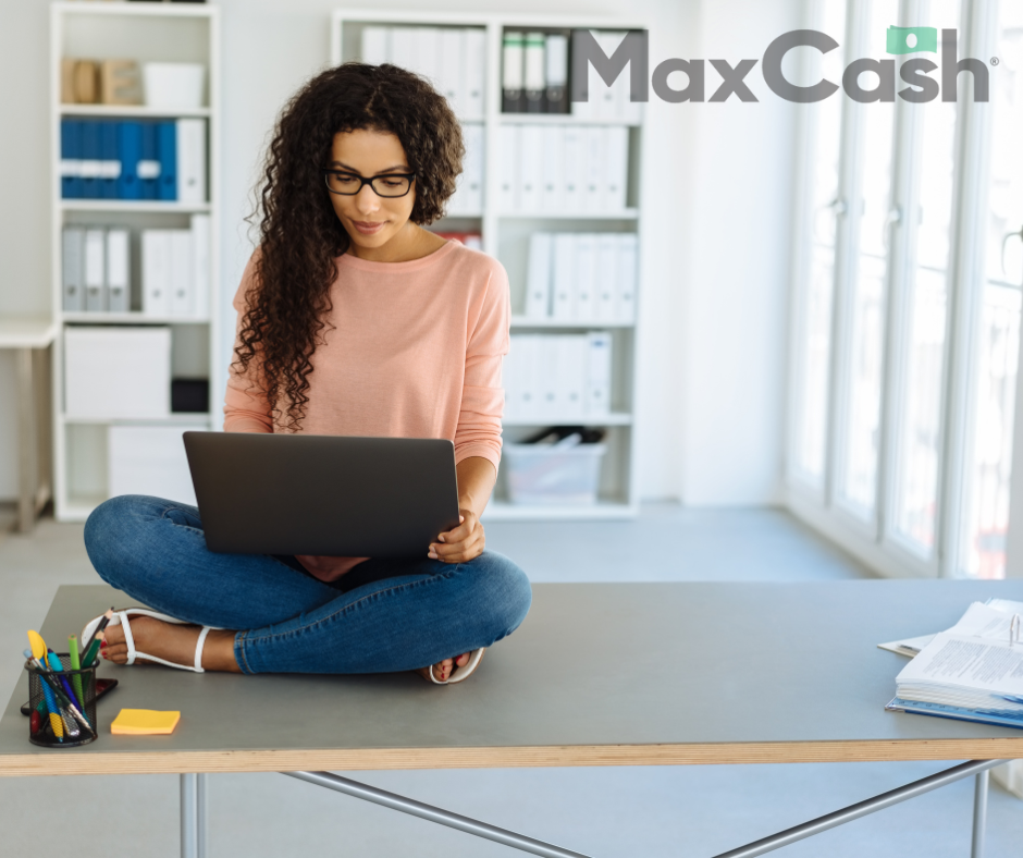 woman sitting on the floor holding a computer