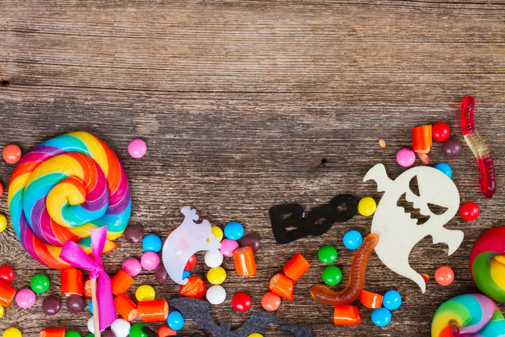 Colorful halloween candies on wood