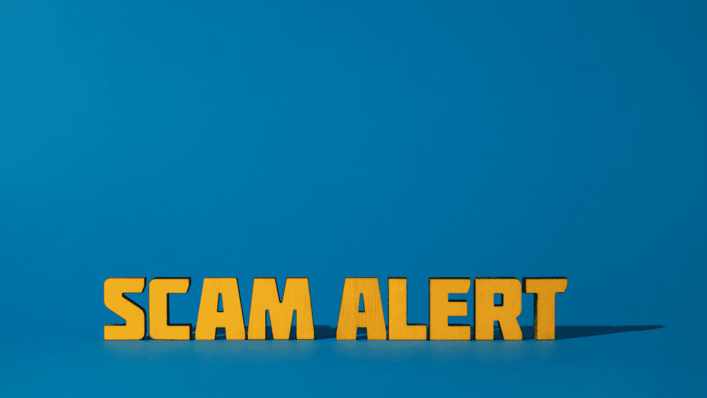 A sign that says "scam alert"